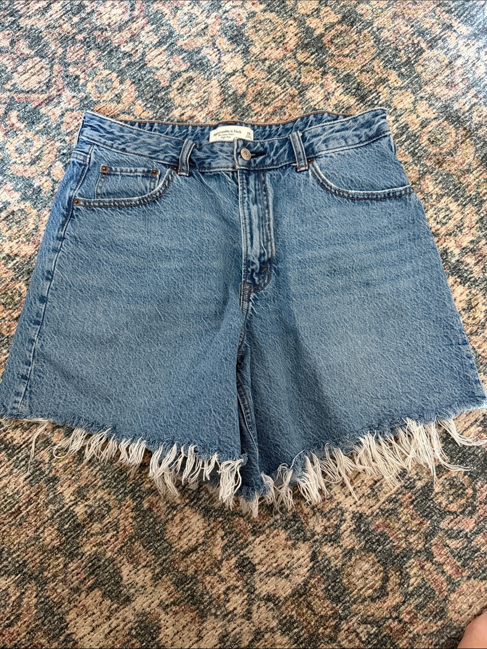 Abercrombie & Fitch denim shorts featuring a distinctive long frayed fringe hem